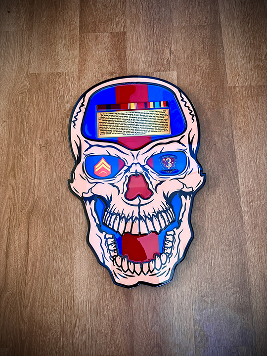 Skull-shaped object with colorful design on a wooden surface